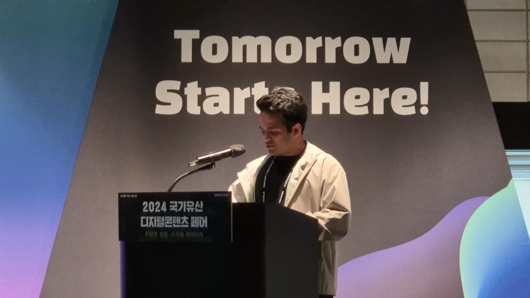 Danyal presenting on stage at the heritage contest final