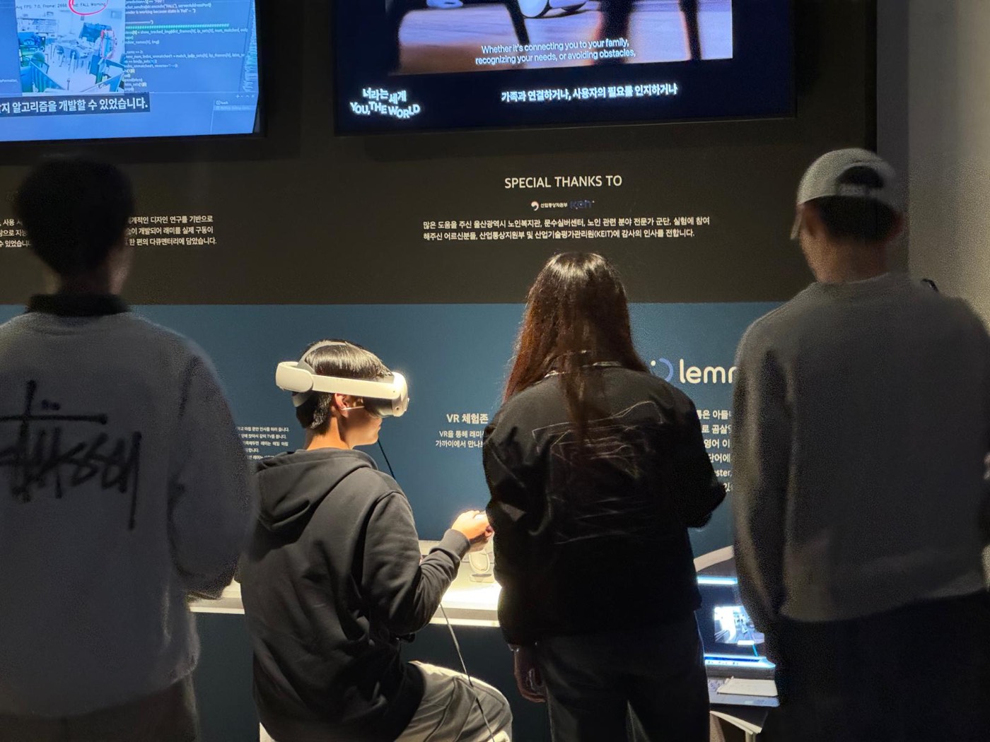 Visitors at the Lemmy exhibit, one wearing a VR headset
