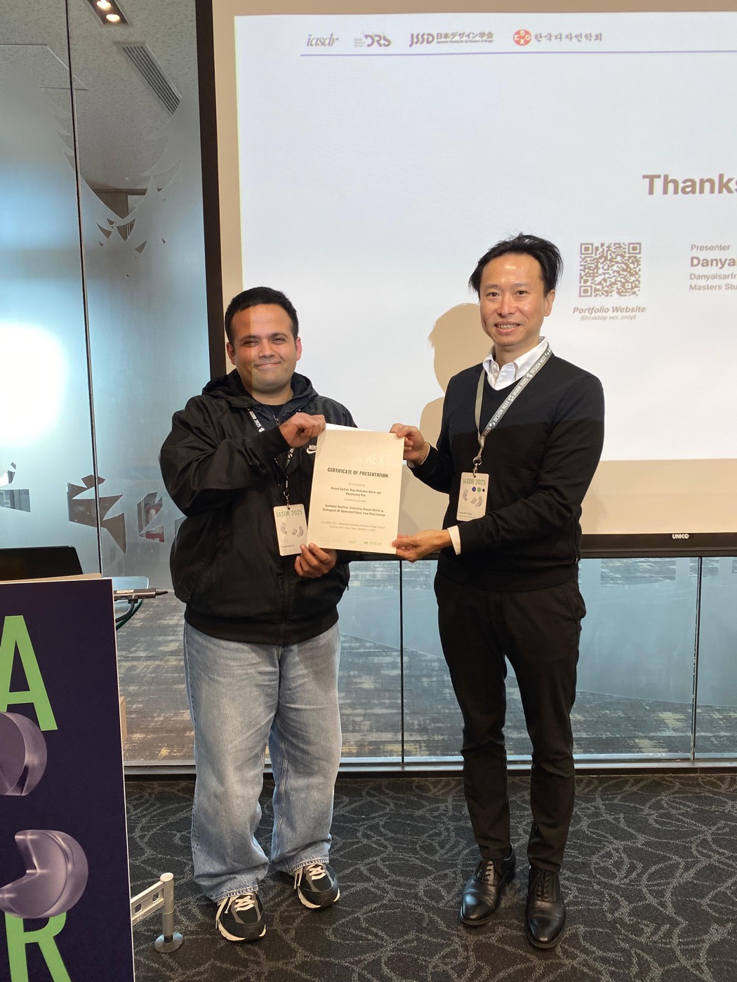 Danyal and a colleague holding presentation certificates