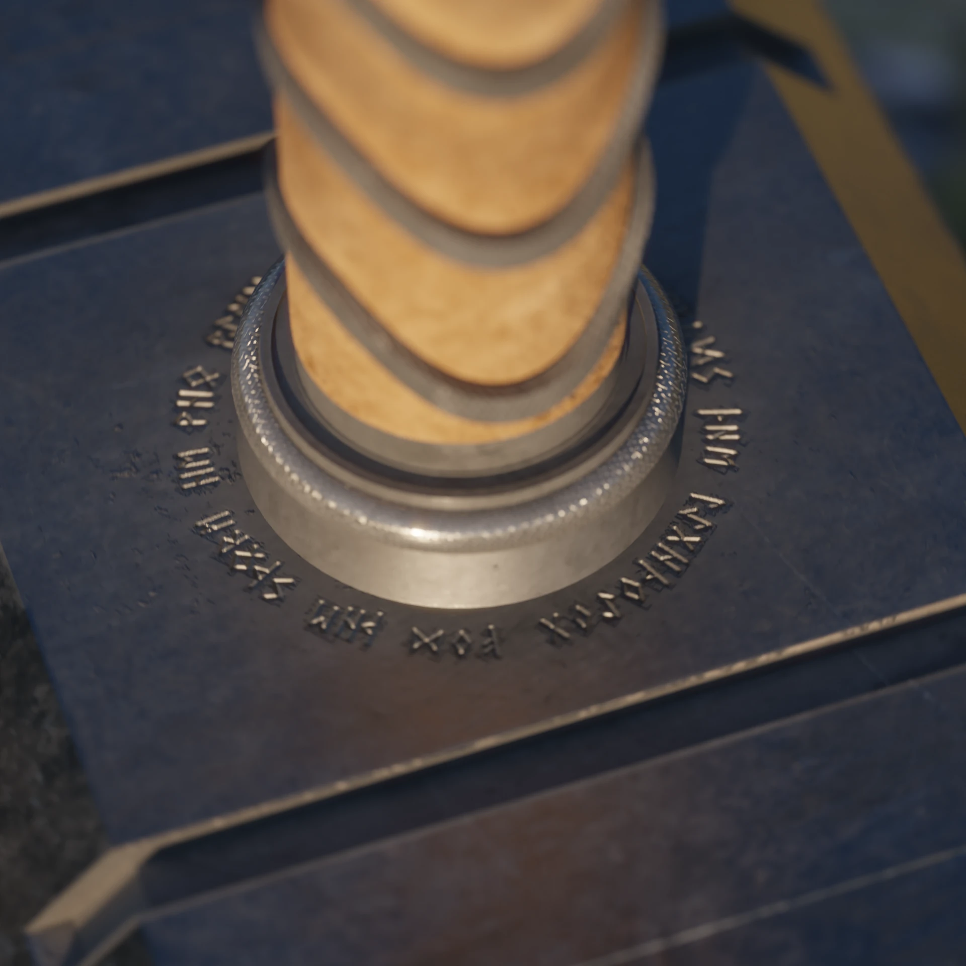 The base of the handle: a knurled steel collar ringed by engraved runes